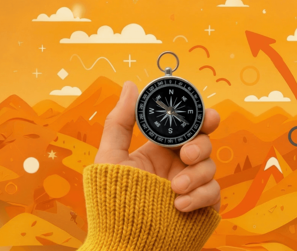 Orange Hintergrund, eine Hand, die einen Kompass hält